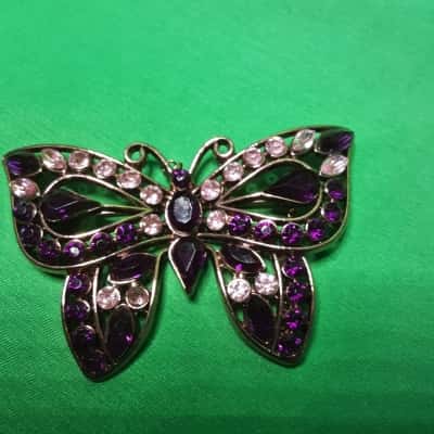 Butterfly brooch featuring magical cerise and pink rhinestones in copper tone metal Setting