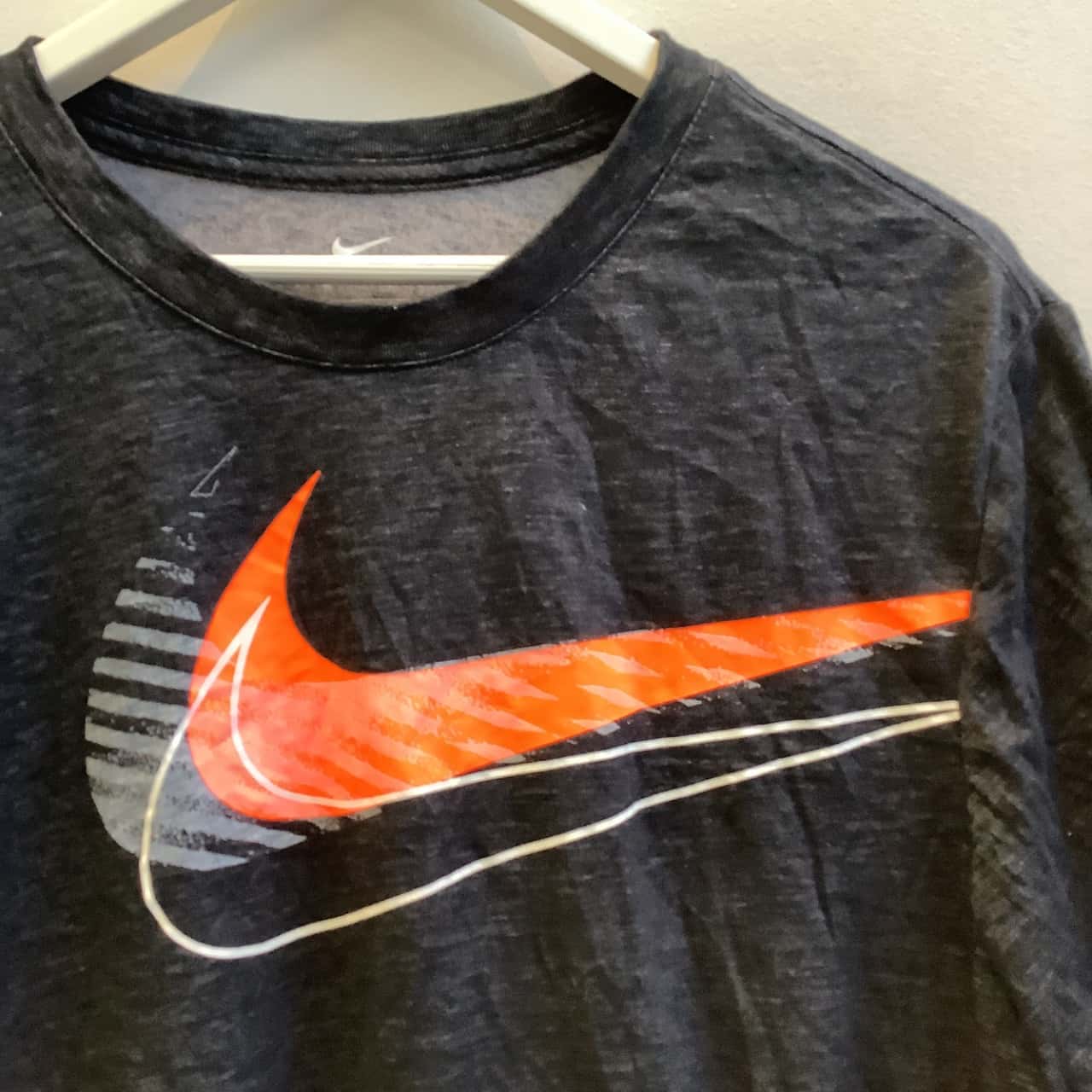 black nike shirt with orange swoosh