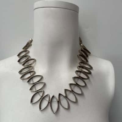 Silver Toned statement necklace with articulated  design with repeated almond shape open links