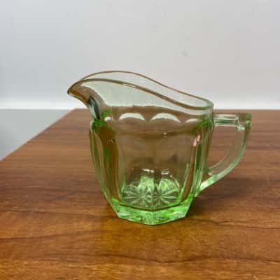 Green depression glass milk jug / creamer with starburst pattern on base