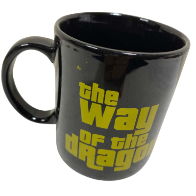 a black ceramic mug featuring the yellow text "the Way of the Dragon"