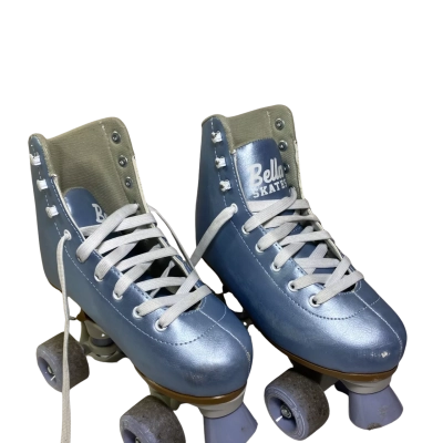 Bella Skates Light Blue Quad Roller Skate. These budget-friendly, vintage-style quad skates feature a distinct metallic light blue high-top boot, white laces, a matching front toe stop, and light blue translucent wheels. 