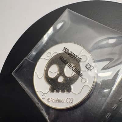Metal Pokémon special condition marker designed for use as a "Poison" or "Burn" token in the Trading Card Game