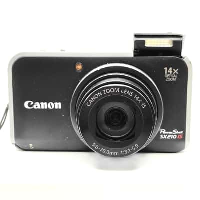 Canon PowerShot SX210IS Compact Digital Camera 14.1MP With 2 Batteries, Charger (needs adapter) & Soft Pouch - Turns On & Appears To Be working Fine. Condition is Great, Screen Still Has Protective Cover On It