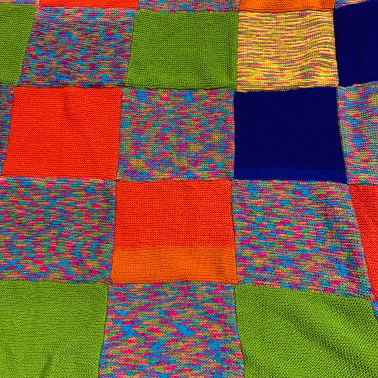 Handmade knitted blanket. Multicoloured squares to make a 150 x 170 cm