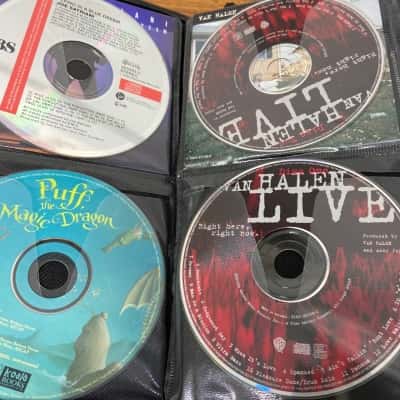 Collection of 50 assorted CDs in carry case