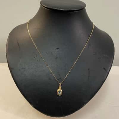 Womens 45cm Curb Chain with Bezel Set Oval Drop Pendant with Light Blue Stone