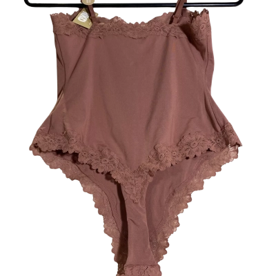 Size 12 NKD Bodysuit from Bras N Things in Black. It is a smooth, high-cut bodysuit featuring delicate lace trim along the neckline and leg openings