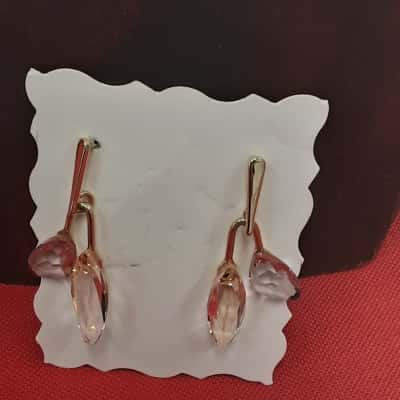 Lunar drop earrings featuring pink teardrop shape crystals in a rose gold tone setting