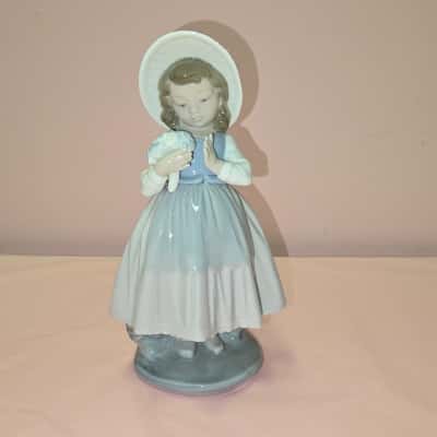 Nao by lladro:  Girl with a bouquet of flowers