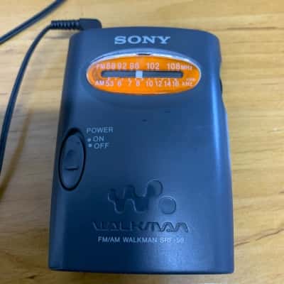 Sony Grey SRF 59 Walkman radio, with ear phone. AMFM