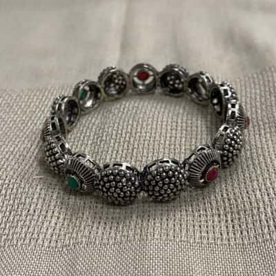  Womens Textured Silver Tone Bangle Bracelet with Red and Green Stones