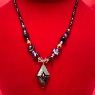 Dark Coloured, Faceted Geometric Pendant Featuring Small Black Beads, With Larger Faceted Beads Necklace