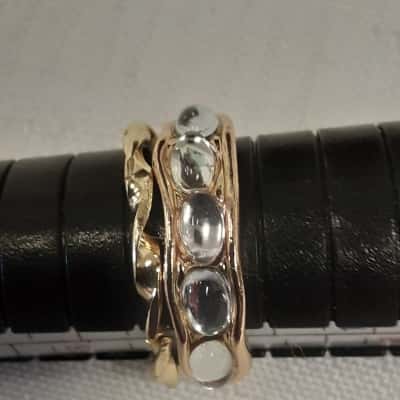2 Gold Tone Rings one featuring five Oval faux moonstones and the other twisted band