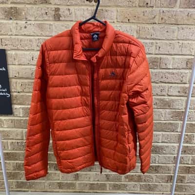 Macpac Mens  Uber Light Down Jacket features a vibrant picante orange  Size S 