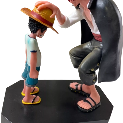 anime figurine depicting Shanks placing the straw hat on a young Monkey D. Luffy from One Piece, mounted on a black hexagonal base labeled "Luffy & Shanks"