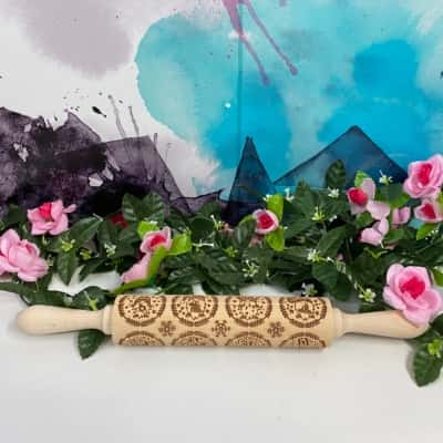 Near new Christmas wooden rolling pin with assorted prints 