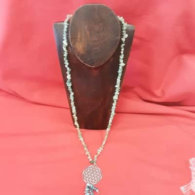 Ladies long beaded necklace featuring a circular geometric pendant