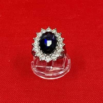  Women’s Silver Tone Costume Ring with a Large Oval Purple Stone surrounded by Smaller Clear Stones