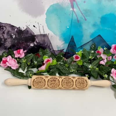 Near new Christmas wooden rolling pin with assorted prints  