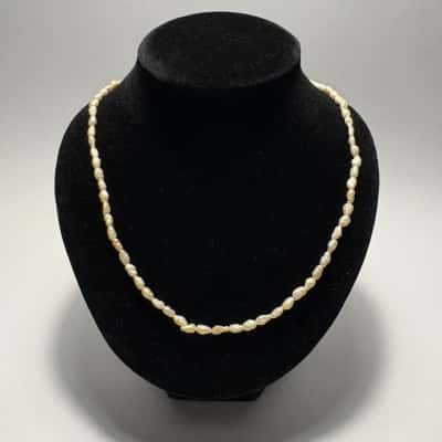  Vtg. Freshwater Rice Pearl strand Necklace featuring a gold-toned clasp