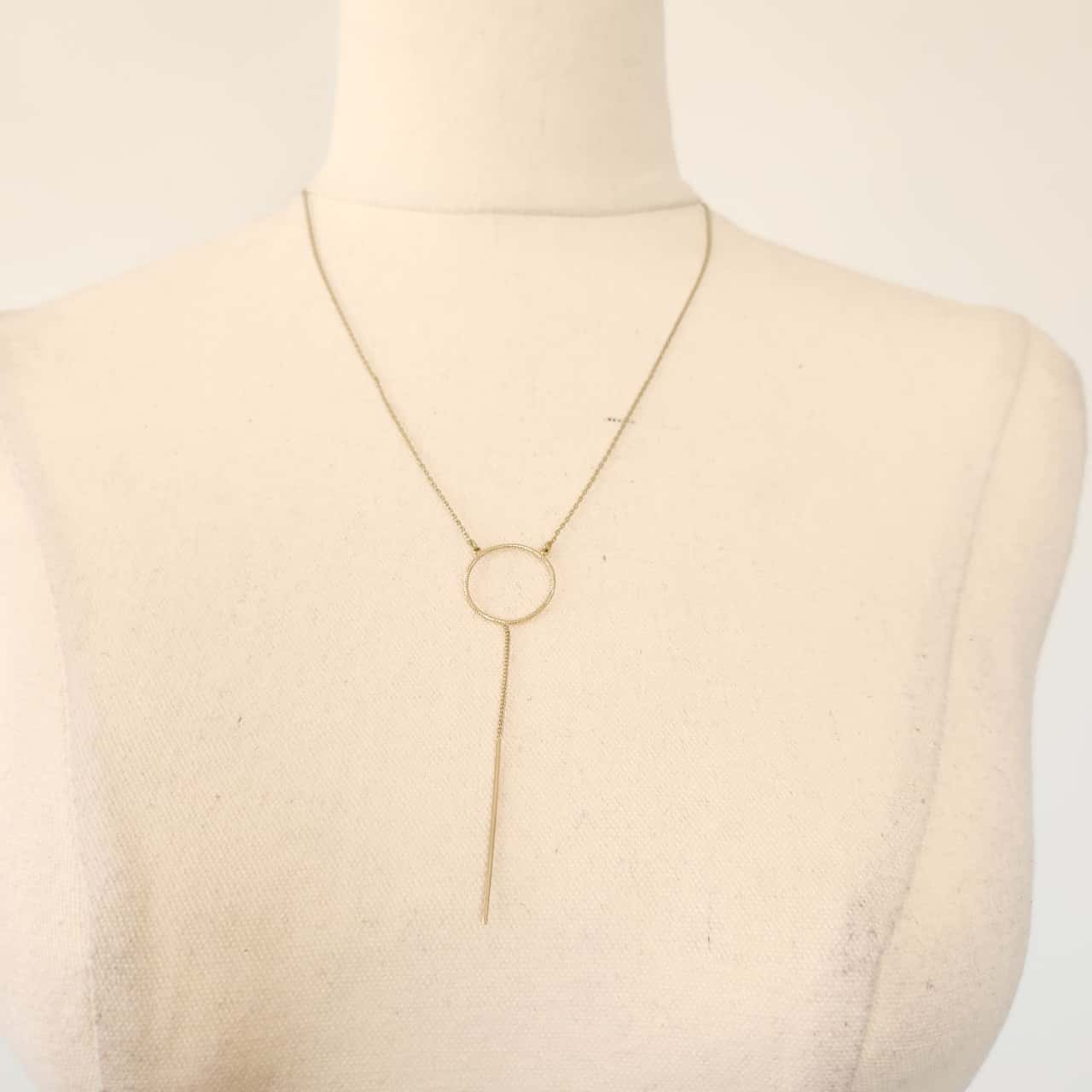 Gold tone circle drop bar necklace
