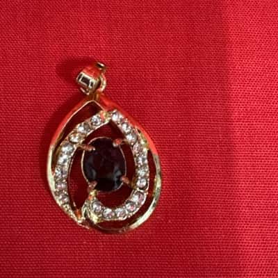 Women's Gold Tone Dark Stone Surrounded by Small Clear Stones Pendant