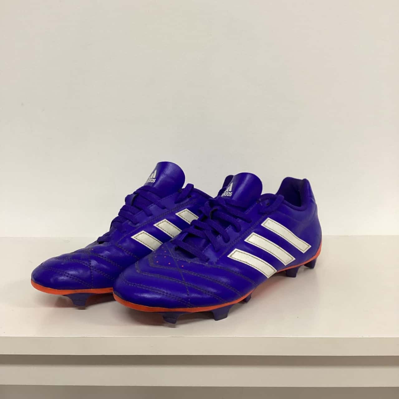 mens orange and black football cleats