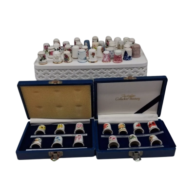 Vintage porcelain and bone china floral collectible thimbles, likely from 1970s and 1980s commemorative sets such as the Franklin Mint collection. 