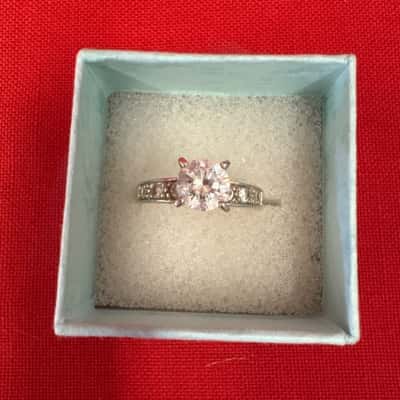  Womens' 925 Silver Ring featuring a Round Brilliant Cut Stone with Smaller Stones Channel-Set into the Shoulders
