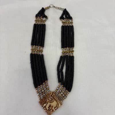  Women's Multi -Strand Black & Tan Beaded Necklace with an Carved Elephant Pendant 