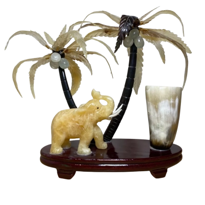 Carved yellow jade elephant, horn and palm trees keepsake statue