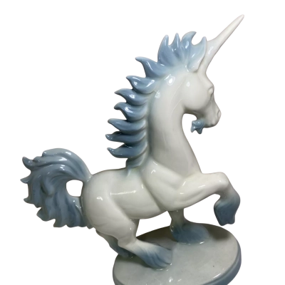 vintage porcelain unicorn figurine features a glossy white finish with blue-tinted accents on the mane, tail, and hooves.