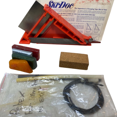 Ski-Doc" home ski tuning kit. It is a set of tools designed to help users maintain their ski edges and bases for better performance and safety