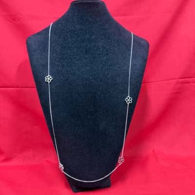  Womens Delicate silver tone chain adorned with four open flower motifs 