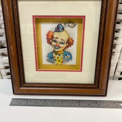 vintage 3D paper tole art piece depicting a smiling clown with orange hair, a small blue hat, and a white flower