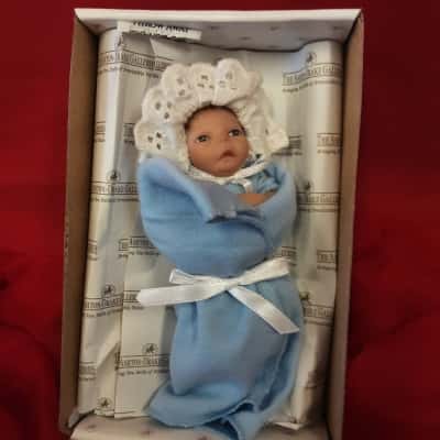 The Ashton Drake's hand full of purity miniature doll with certificate of authenticity