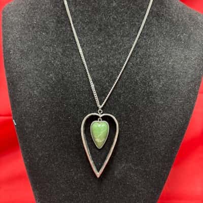 Women's Silver Tone Heart Pendant Necklace featuring a Green Heart Shape Gemstone Set Within an Intricate Scroll Pattern Metal Heart Frame