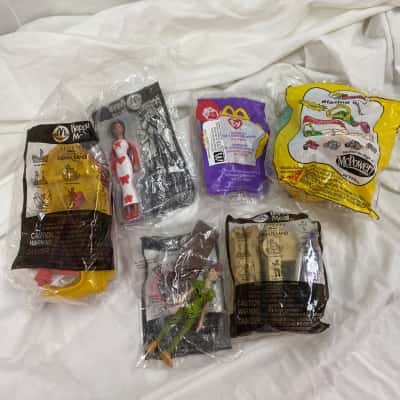 various Mcdonalds toys still in bag, Peter Pan, Birdie, Barbie and TY
