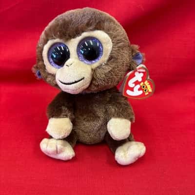 Ty Beanie Boo Plush Toy named Coconut the Monkey  featuring Large Purple Glittery Eyes