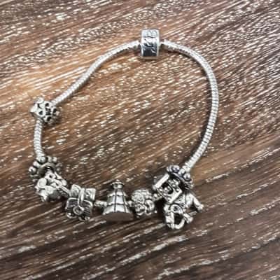 Biz beads Silvertone bracelet featuring 8 charms