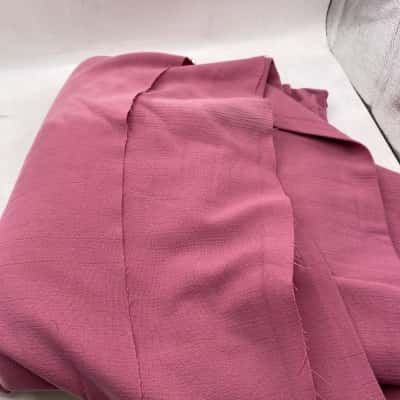 Rose pink crepe synthetic mix fabric.  140 (w) x 525 (L) cm approx.  See photos for sun fading)