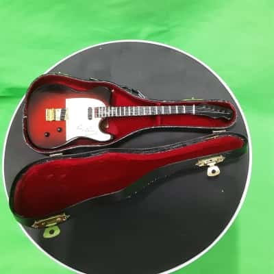 Miniature Graceland Elvis Presley guitar in velvet lined box with stand