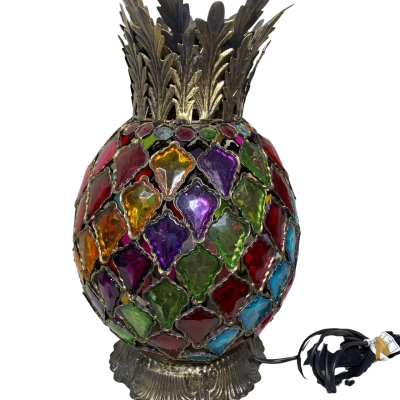 vintage-style pineapple lamp features a colorful stained-glass shade with brass-colored metal leaves