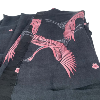 Synthetic fabric, but feels like silk.  135 (w) x 140 (L) cm approx.  Black with cranes.