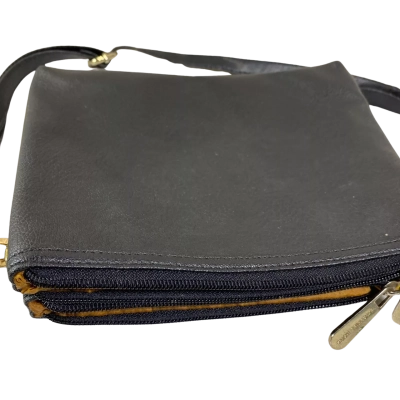 black textured leather Michael Kors crossbody bag, accented by a striking round gold MK logo on the front zipper compartment. 20x15 cm