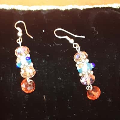  Hand made beaded dangle earrings featuring red blue and pink beads on silver tone metal