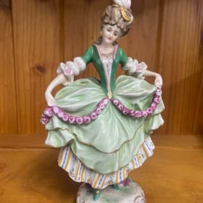 Vintage porcelain figurine resembling Victorian-style Lady