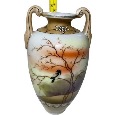 vintage two-handled porcelain vase, likely an antique hand-painted Nippon or Royal Nishiki piece featuring a scenic tree and bird motif with gold trim. 