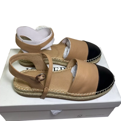 A pair of two-tone leather espadrille slingback sandals by Jo Mercer, characterized by a tan (beige) body, a contrasting black round toe, an adjustable ankle strap with a buckle, and a braided jute/raffia-trimmed sole.